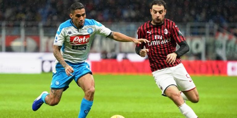 Jens-Lys Cajuste of SSC Napoli competes for the ball with Milan